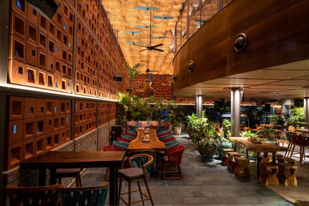 Tropical open-air dining court with terracotta walls at Makau